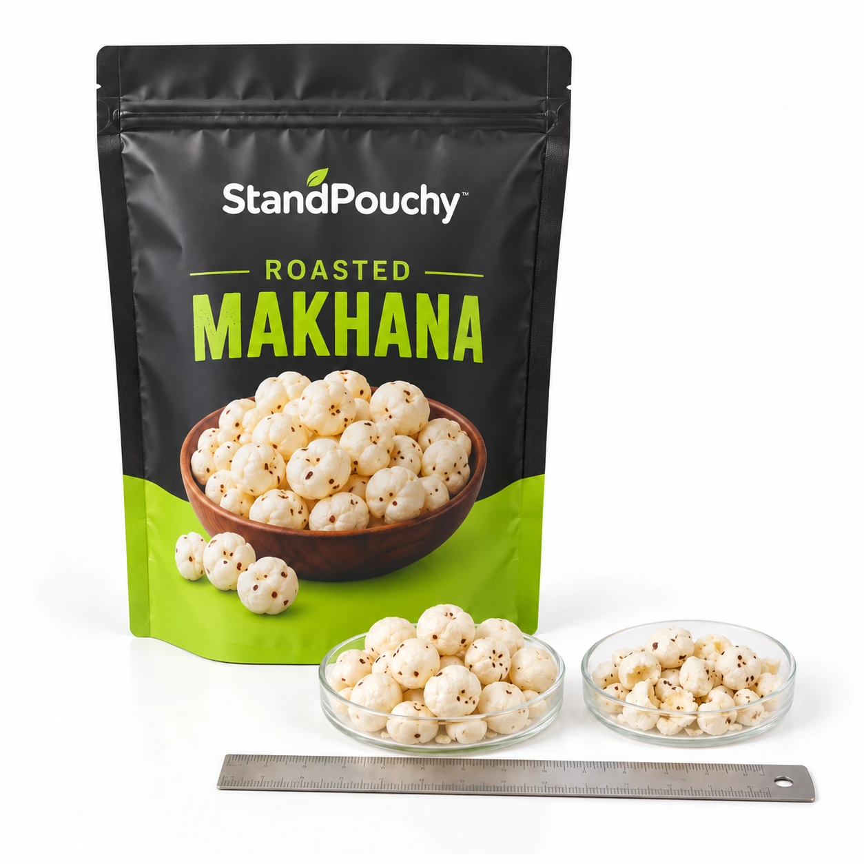 Roasted makhana pouch beside clear dishes of whole and broken popped fox nuts and a ruler